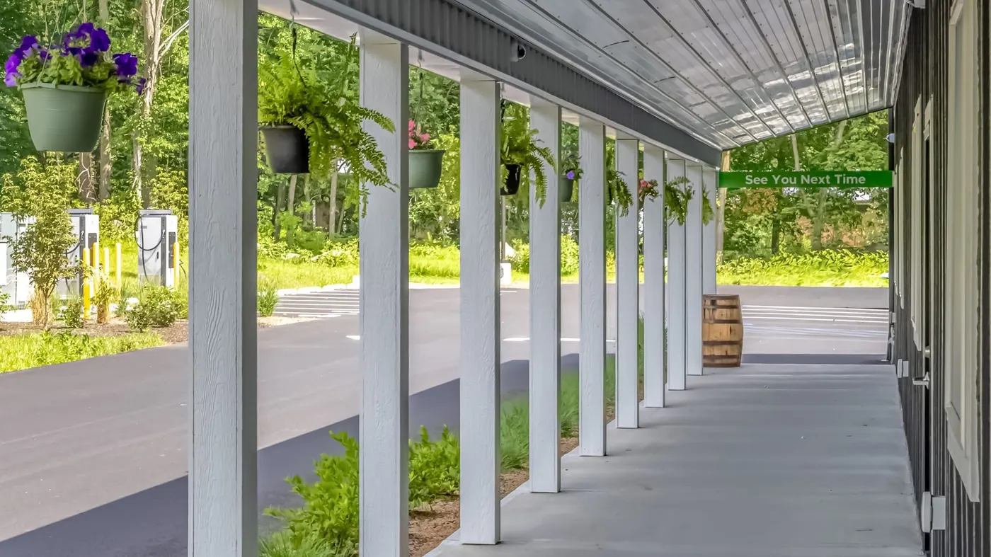 Covered porch of Farmers Choice dispensary with hanging flower baskets