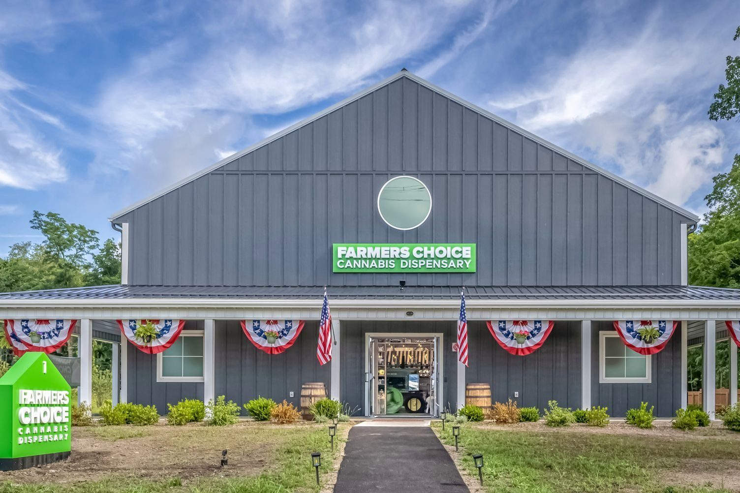 Farmers Choice dispensary building with American flags and green sign