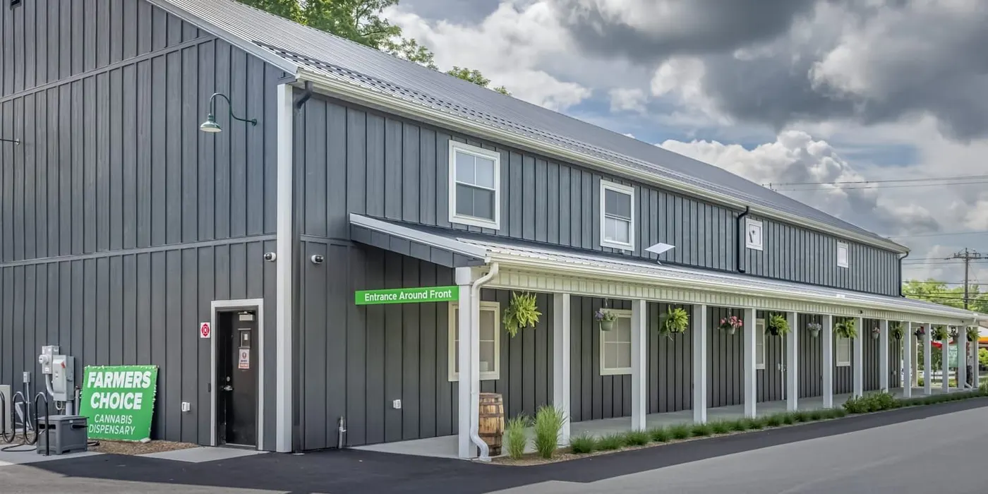 Side view of Farmers Choice dispensary building with green sign
